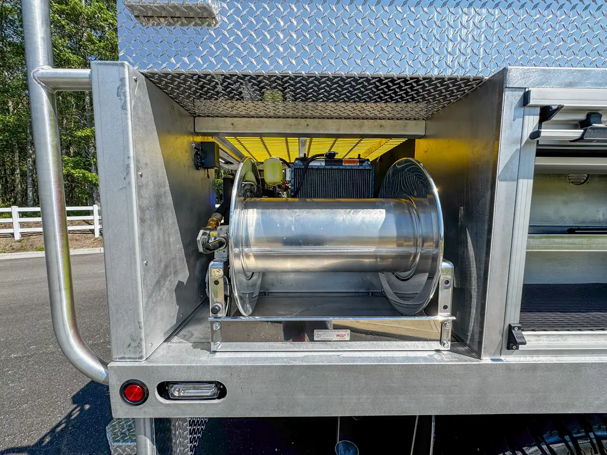 Rear underside view showing axle, frame, and mudflap behind the truck.